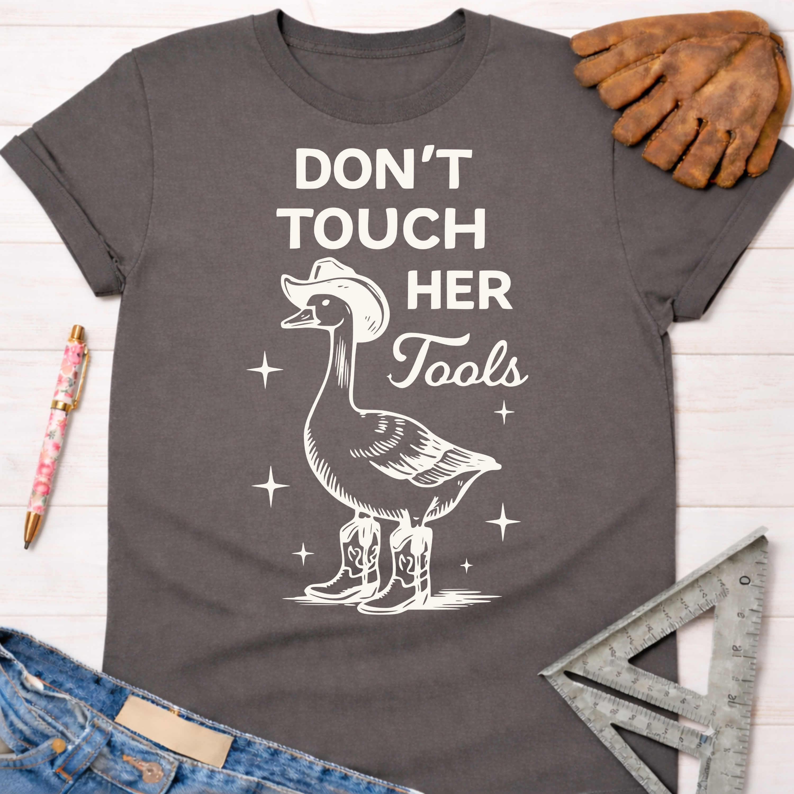 Charcoal cotton tee with "Don't Touch Her Tools" and a goose in a cowboy hat and boots. Women's funny woodworking graphic tee shirt for female woodworkers, makers, and DIY builders — Sawdust & Ponytails