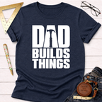 Dad Builds Things funny woodworking t-shirt, distressed white lettering on navy – Sawdust & Ponytails (view 1)