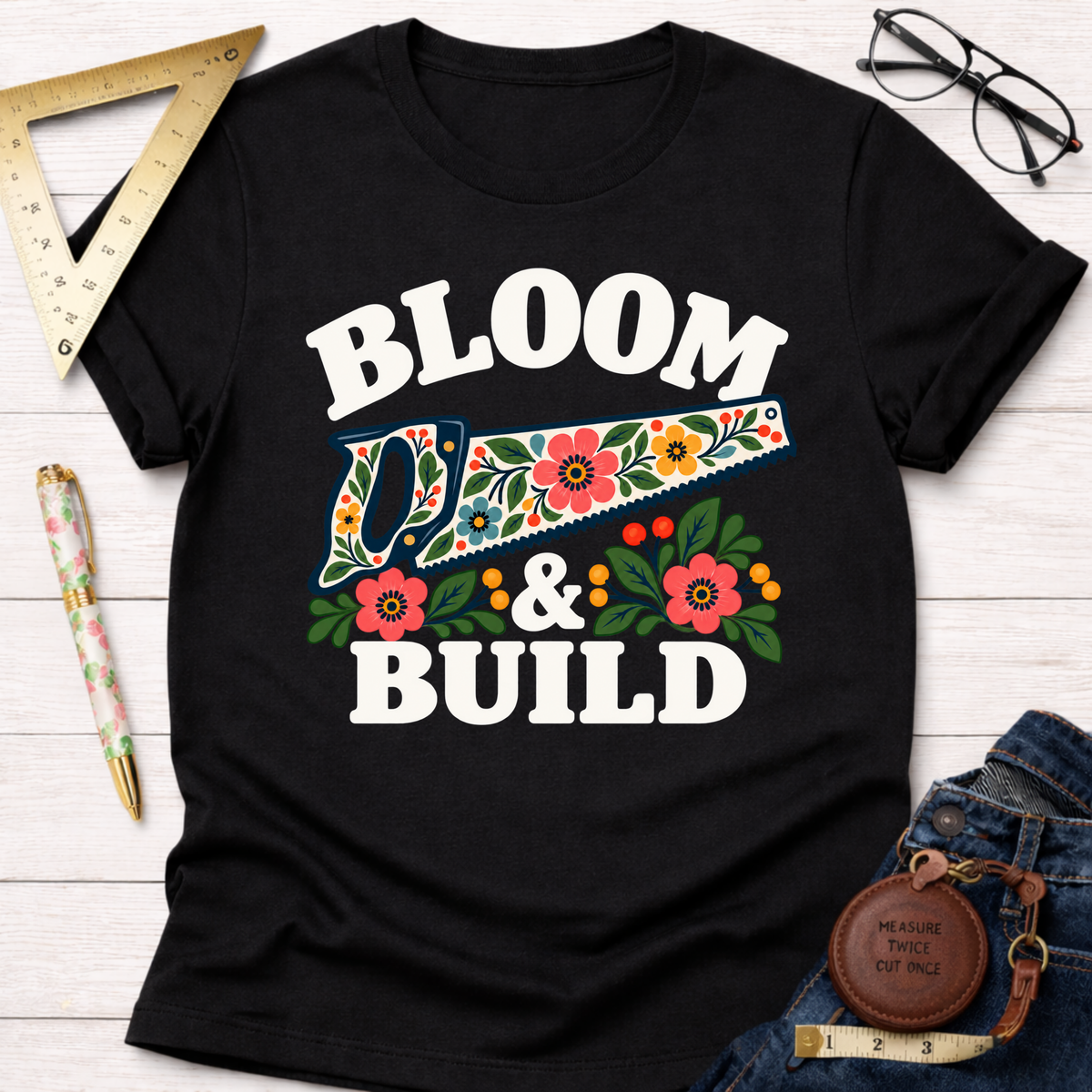 Bloom & Build woodworking t-shirt, floral handsaw design on black – Sawdust & Ponytails (view 1)