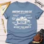 Women's funny woodworking graphic tee shirt for female woodworkers, makers, and DIY builders — Sawdust & Ponytails. Light blue cotton tee with "Anatomy of a Bad Cut" table saw graphic.