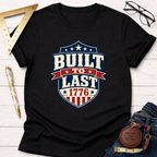 Black cotton t-shirt with a "Built To Last 1776" badge design in red, white, and blue.