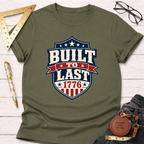 Olive green "Built To Last 1776" badge t-shirt with red, white, and blue design.