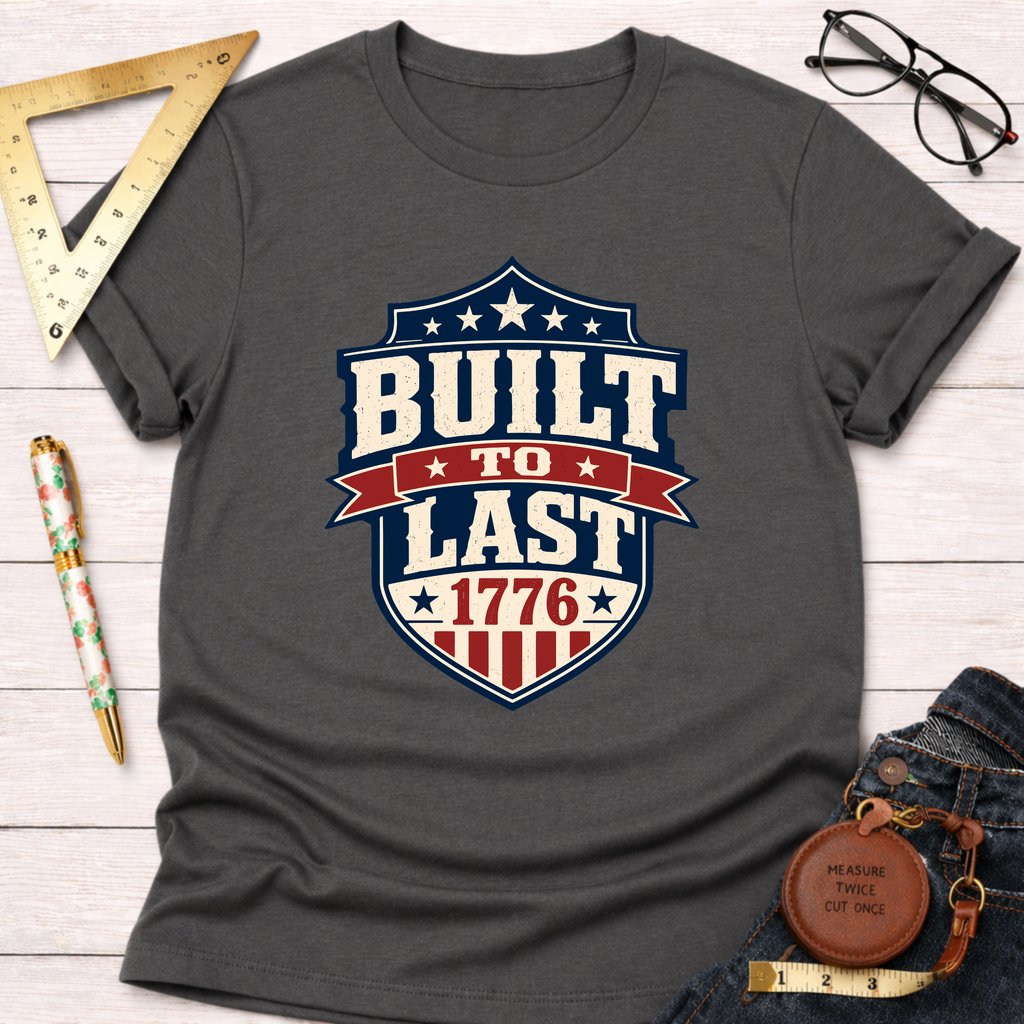 Charcoal gray cotton t-shirt with a "Built To Last 1776" patriotic badge design.
