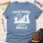 Blue cotton t-shirt with "Calm Hands Sharp Skills" text and a hand plane graphic.