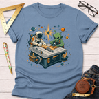 Light blue cotton t-shirt with an astronaut and alien woodworking at a table saw, surrounded by planets.