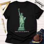 Black cotton t-shirt with a green Lady Liberty graphic and "CRAFTED IN AMERICA" text.