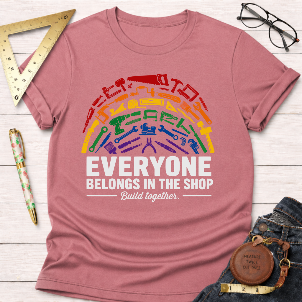 Unisex dusty rose t-shirt with a rainbow of tools and "Everyone Belongs In The Shop Build together" text.