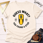 Cream t-shirt with "Guess What? You Found A Stud" text and a yellow stud finder graphic.