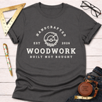 Charcoal gray cotton t-shirt with "Handcrafted Woodwork Built Not Bought" text and saw blade graphic.