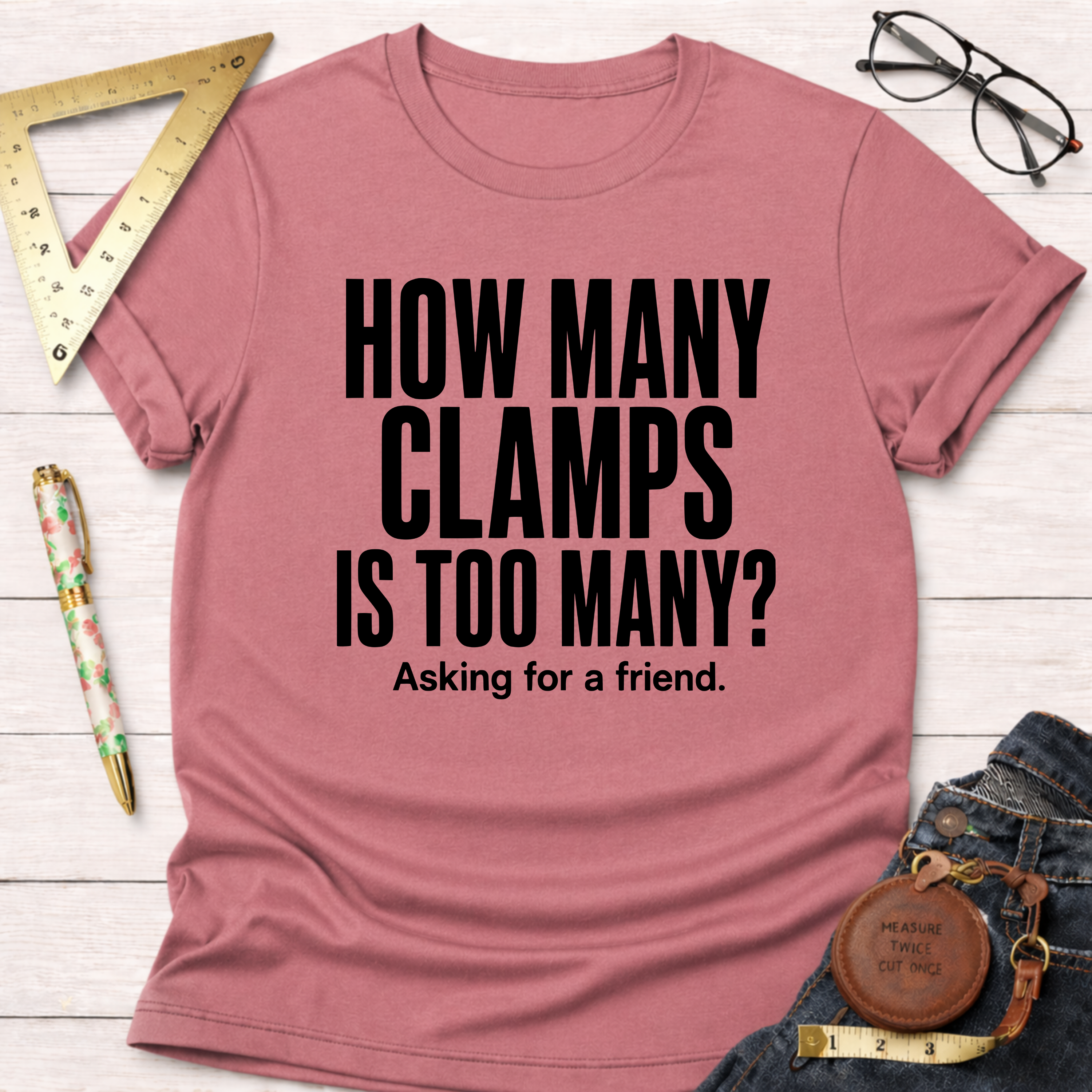 Heather dust pink t-shirt with "HOW MANY CLAMPS IS TOO MANY? Asking for a friend." in black text.
