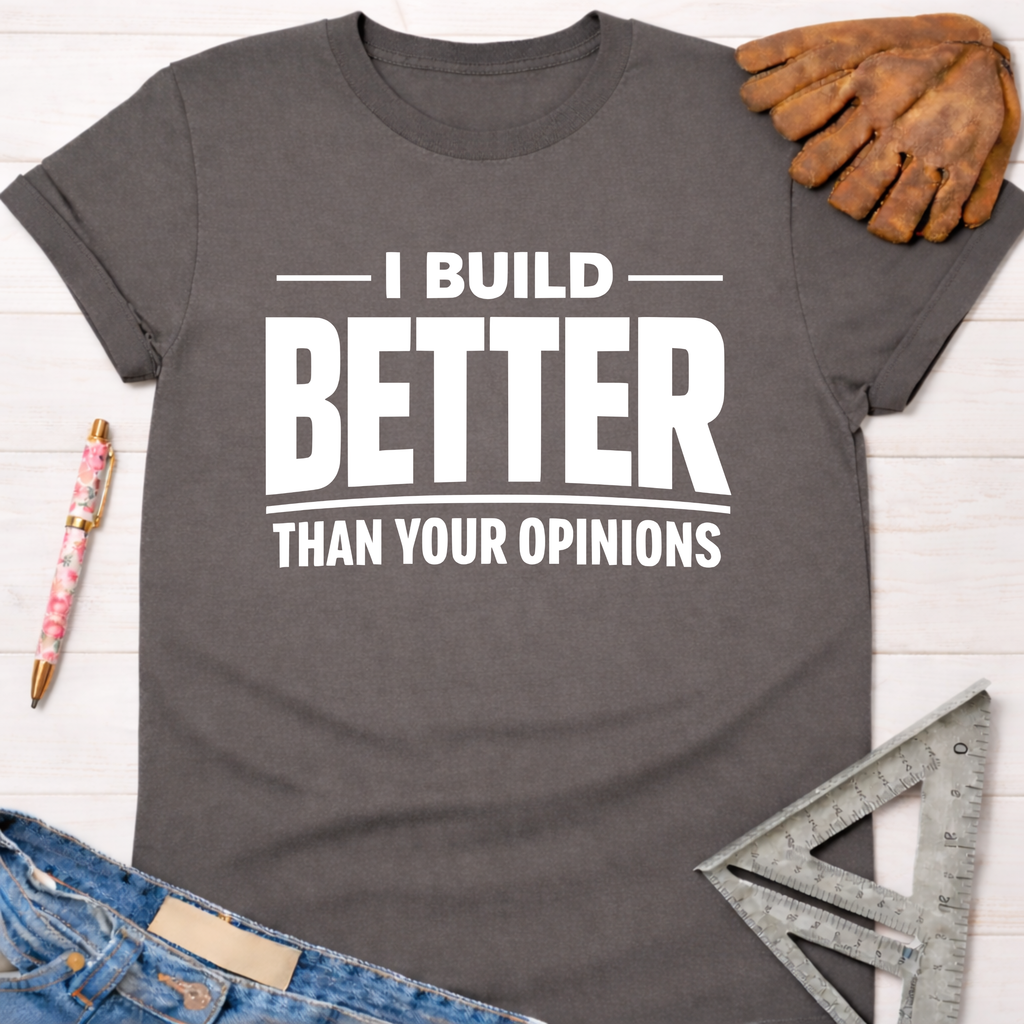 Women's funny woodworking graphic tee shirt for female woodworkers, makers, and DIY builders — Sawdust & Ponytails. Dark gray cotton tee with "I BUILD BETTER THAN YOUR OPINIONS" in white text.