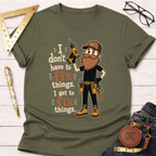 Olive green cotton t-shirt with a cartoon handyman holding a drill and the text "I don't have to fix things. I get to fix things.