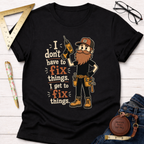 Black cotton t-shirt with a cartoon handyman holding a drill and the text "I don't have to fix things. I get to fix things.