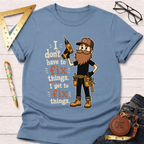 Light blue cotton t-shirt with a cartoon handyman holding a drill and the text "I don't have to fix things. I get to fix things.