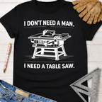 Women's funny woodworking graphic tee shirt for female woodworkers, makers, and DIY builders — Sawdust & Ponytails. Black cotton tee with "I DON'T NEED A MAN. I NEED A TABLE SAW." text and graphic.