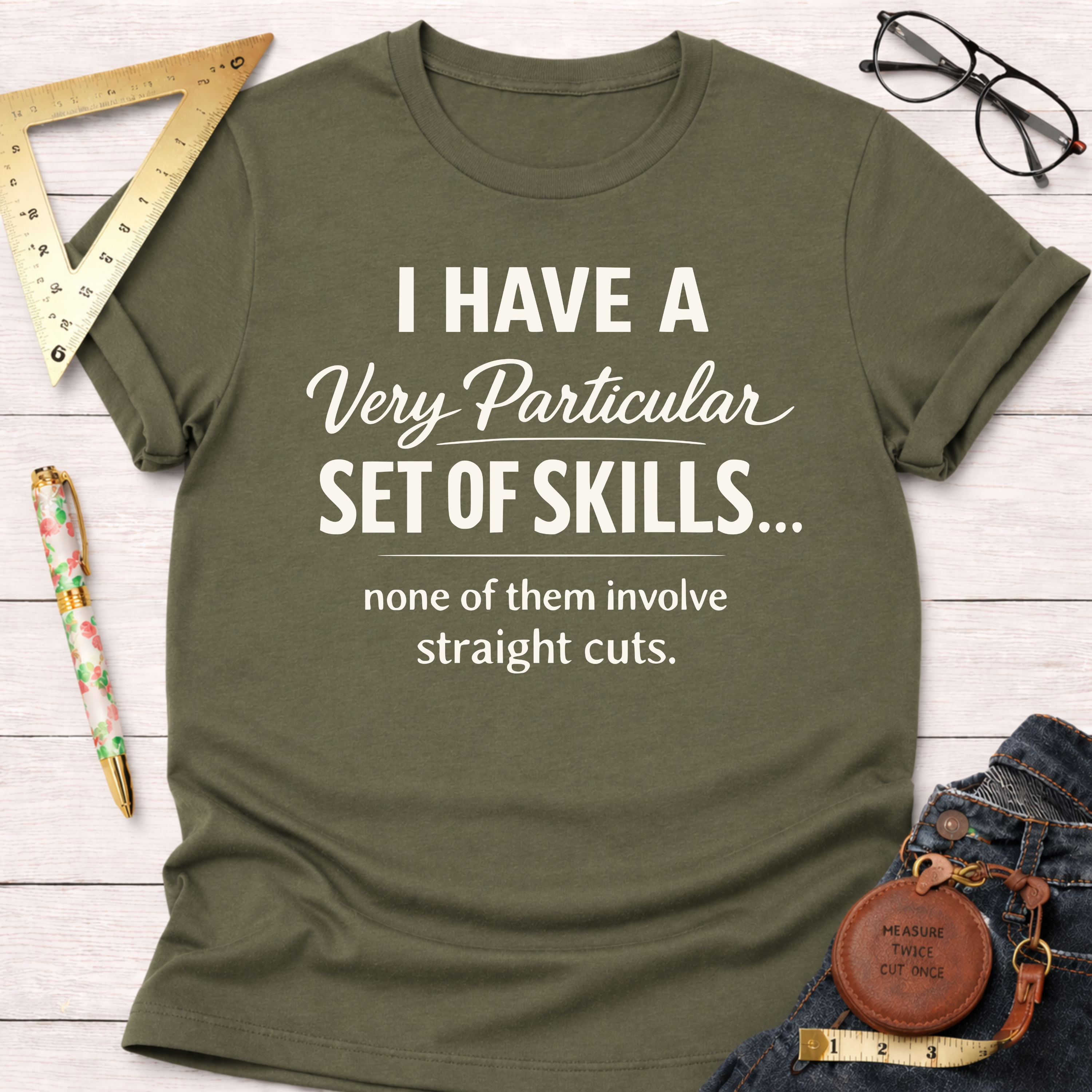Heather mauve t-shirt with "I have a very particular set of skills... none of them involve straight cuts" text.