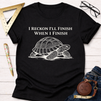 Women's funny woodworking graphic tee shirt for female woodworkers, makers, and DIY builders — Sawdust & Ponytails. Black cotton tee with white "I Reckon I'll Finish When I Finish" text and turtle graphic.