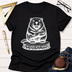 Women's funny woodworking graphic tee shirt for female woodworkers, makers, and DIY builders — Sawdust & Ponytails. Black cotton tee with white beaver graphic holding wood on a tree stump, text "I'M GOOD WITH WOOD".