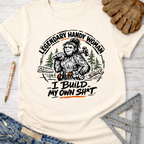 Cream t-shirt with "Legendary Handy Woman I Build My Own Sh*t" Bigfoot graphic. Women's funny woodworking graphic tee shirt for female woodworkers, makers, and DIY builders — Sawdust & Ponytails