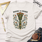 Off-white cotton t-shirt with "Made To Make" text and a colorful, ornate paint brush design.
