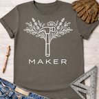 Women's funny woodworking graphic tee shirt for female woodworkers, makers, and DIY builders — Sawdust & Ponytails. Dark gray t-shirt with white floral hammer "MAKER" graphic.