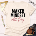 Cream "Maker Mindset All Day" graphic t-shirt with black and pink text, styled with jeans and tools.