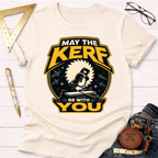 Cream cotton t-shirt with "May The Kerf Be With You" graphic featuring a circular saw and spaceships.