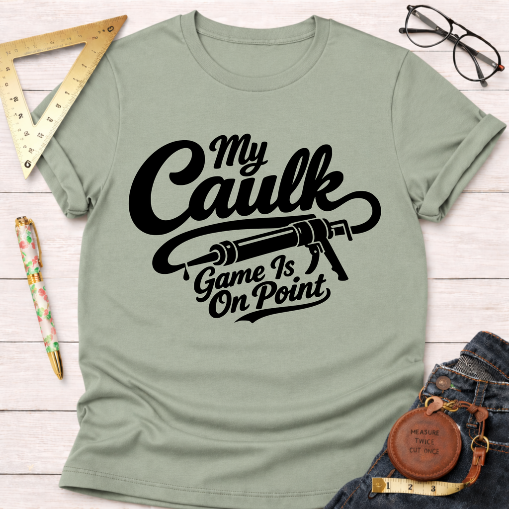 Light green cotton t-shirt with "My Caulk Game Is On Point" text and caulk gun graphic.
