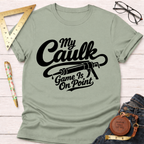 Light green cotton t-shirt with "My Caulk Game Is On Point" text and caulk gun graphic.