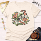 Cream t-shirt with a green miter saw design surrounded by pink and white flowers.