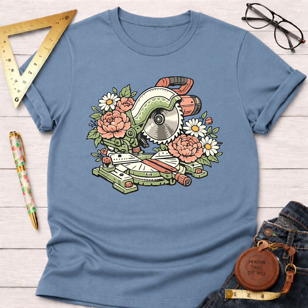 Blue t-shirt with a floral miter saw design, surrounded by pink peonies and white daisies.
