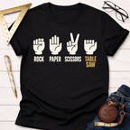 Black cotton t-shirt with "Rock Paper Scissors Table Saw" graphic and hand gestures in white and gold.