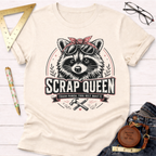 Cream cotton t-shirt with a "Scrap Queen" raccoon wearing sunglasses and a bandana, surrounded by tools.