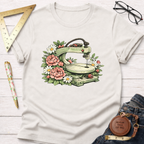 Cream t-shirt with a vintage scroll saw surrounded by pink peonies and white daisies.