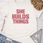 White cotton "SHE BUILDS THINGS" tee, Women's funny woodworking graphic tee shirt for female woodworkers, makers, and DIY builders — Sawdust & Ponytails