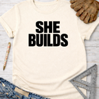 Cream "SHE BUILDS" graphic tee, women's funny woodworking shirt for makers & DIY builders — Sawdust & Ponytails.