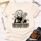 Cream t-shirt with a black graphic of Einstein holding a ruler and wood, text reads "The Numbers Checked Out The Board Didn't".