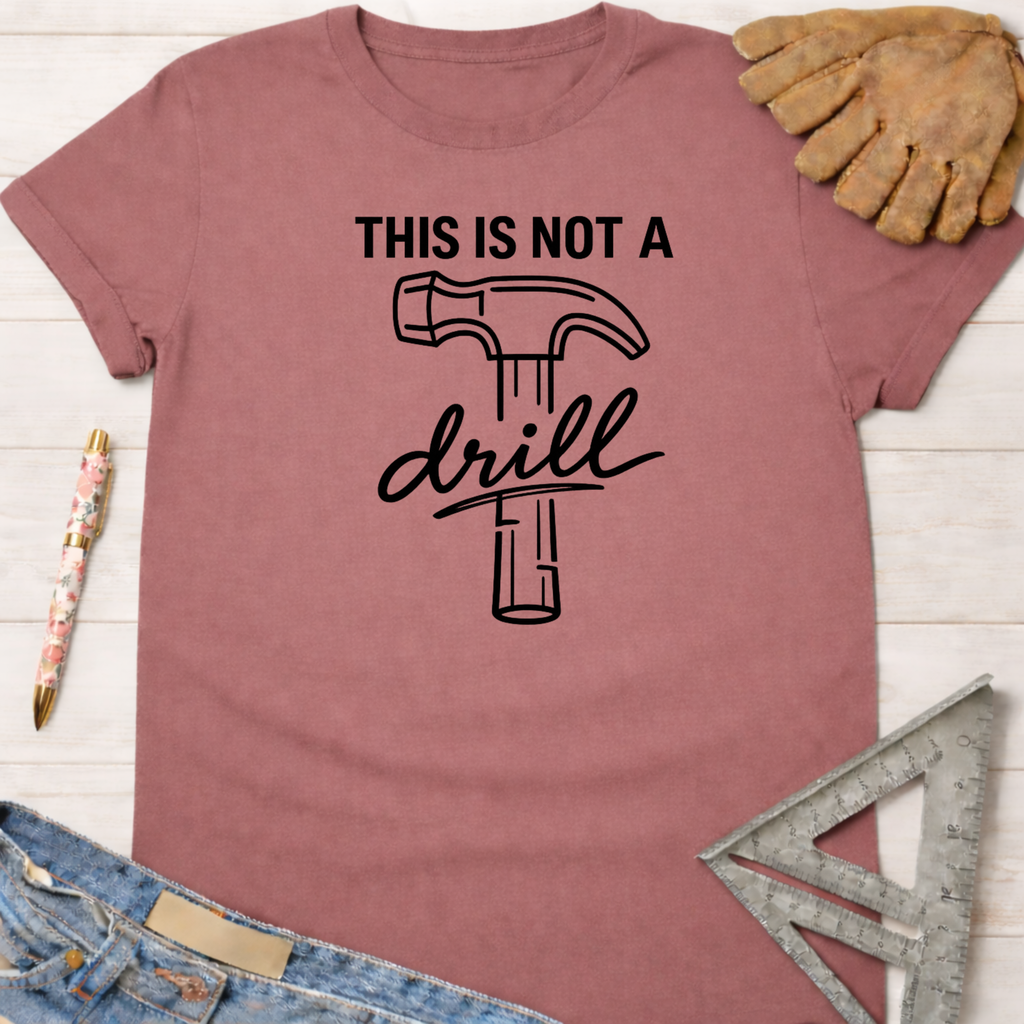 Women's funny woodworking graphic tee shirt for female woodworkers, makers, and DIY builders — Sawdust & Ponytails. Mauve cotton tee with "THIS IS NOT A drill" hammer graphic.