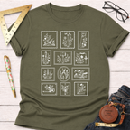 Olive green "Tool Stamps" t-shirt with white woodworking tool graphics, styled on a white wood surface.