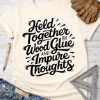Women's funny woodworking graphic tee shirt for female woodworkers, makers, and DIY builders — Sawdust & Ponytails. Cream t-shirt with "Held Together by Wood Glue and Impure Thoughts" in black script.
