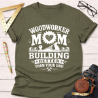 Women's funny woodworking graphic tee shirt for female woodworkers, makers, and DIY builders — Sawdust & Ponytails. Olive green cotton tee with "Woodworker Mom Building Better Than Your Dad" graphic.