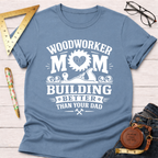Women's funny woodworking graphic tee shirt for female woodworkers, makers, and DIY builders — Sawdust & Ponytails. Light blue cotton tee with "Woodworker Mom Building Better Than Your Dad" graphic.