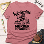 Pink short-sleeve t-shirt with "Woodworking Because Murder Is Wrong" graphic featuring a carpenter.
