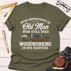 Olive green "Never Underestimate An Old Man Who Still Does Woodworking In His Eighties" t-shirt with tools.