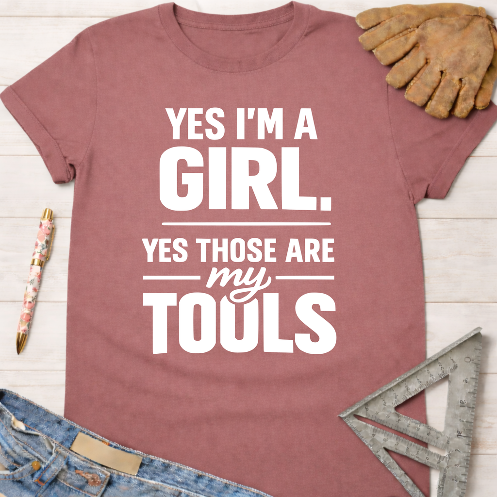 Women's funny woodworking graphic tee shirt for female woodworkers, makers, and DIY builders — Sawdust & Ponytails. Mauve cotton tee with "YES I'M A GIRL. YES THOSE ARE my TOOLS" in white text.