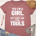 Women's funny woodworking graphic tee shirt for female woodworkers, makers, and DIY builders — Sawdust & Ponytails. Mauve cotton tee with "YES I'M A GIRL. YES THOSE ARE my TOOLS" in white text.