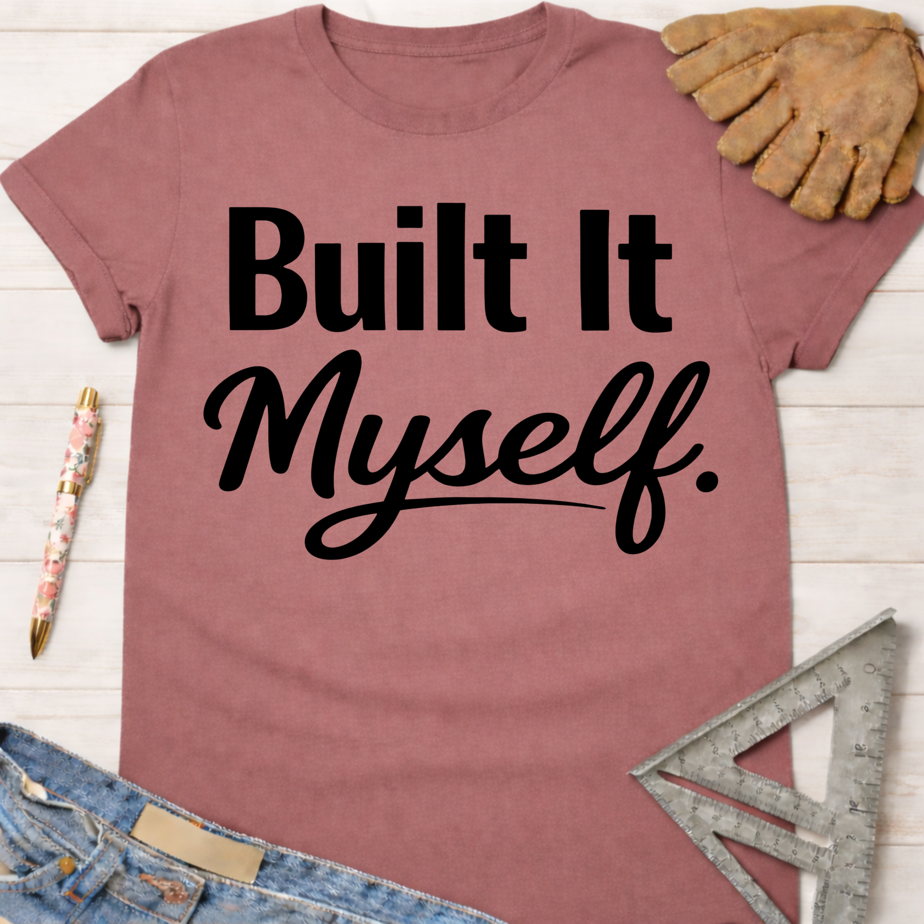 Women's funny woodworking graphic tee shirt for female woodworkers, makers, and DIY builders — Sawdust & Ponytails. Mauve cotton tee with "Built It Myself." in black script.