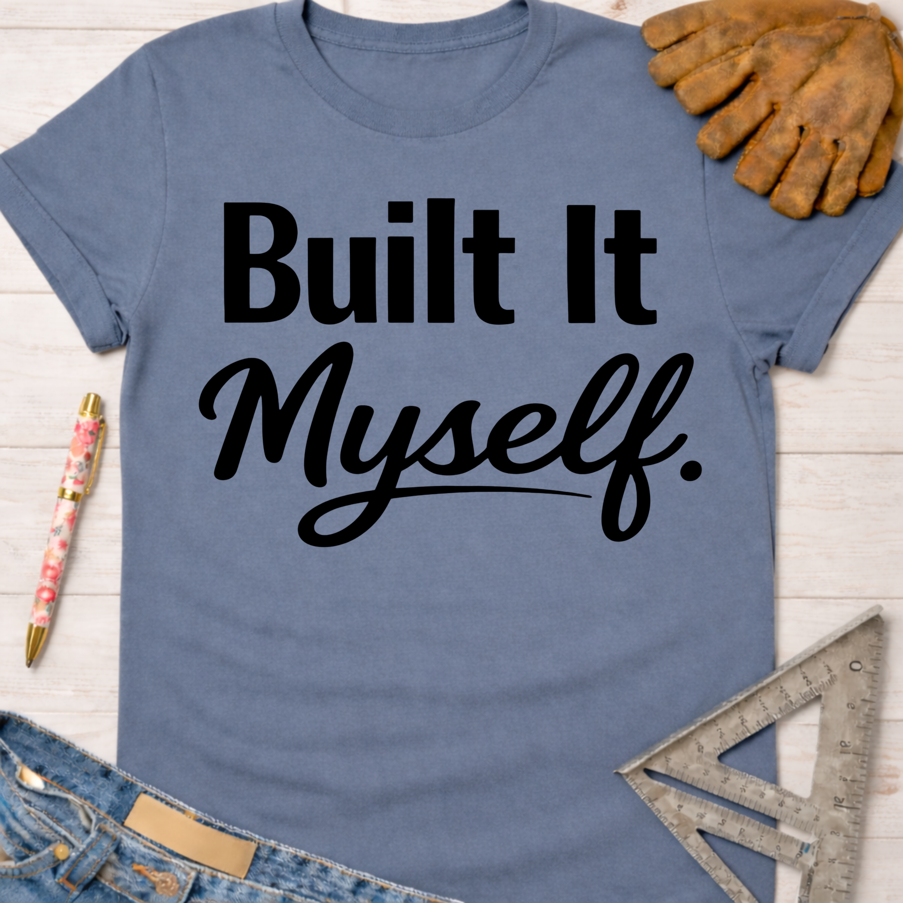 Women's funny woodworking graphic tee shirt for female woodworkers, makers, and DIY builders — Sawdust & Ponytails. Blue cotton tee with "Built It Myself" in black text.