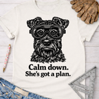 Women's funny woodworking graphic tee shirt for female woodworkers, makers, and DIY builders — Sawdust & Ponytails. White cotton t-shirt with a black schnauzer wearing goggles and "Calm down. She's got a plan." text.
