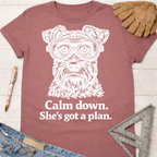 Women's funny woodworking graphic tee shirt for female woodworkers, makers, and DIY builders — Sawdust & Ponytails. Mauve t-shirt with a white graphic of a dog wearing safety goggles and the text "Calm down. She's got a plan.